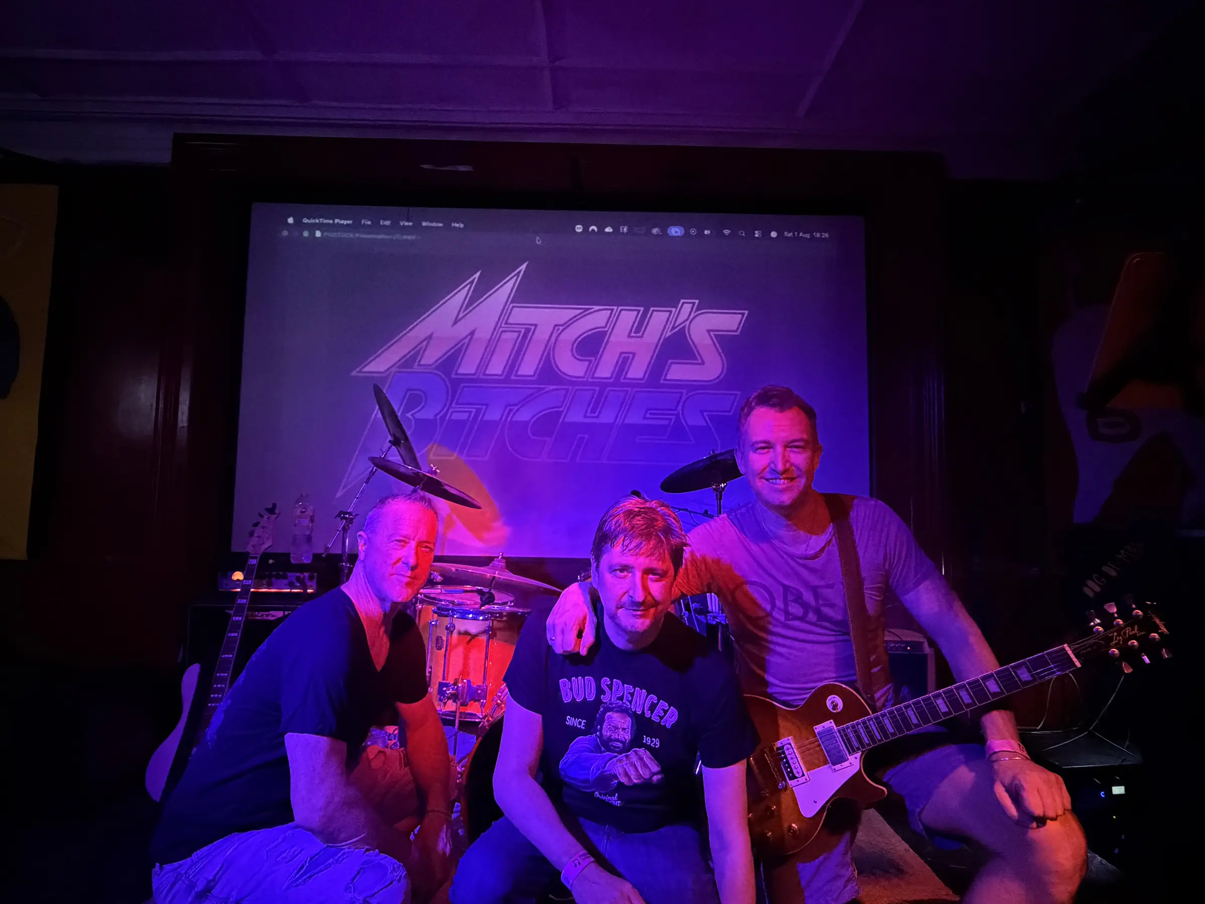 Mitch's bBtches pose at the front of the stage in front of their logo following their set.