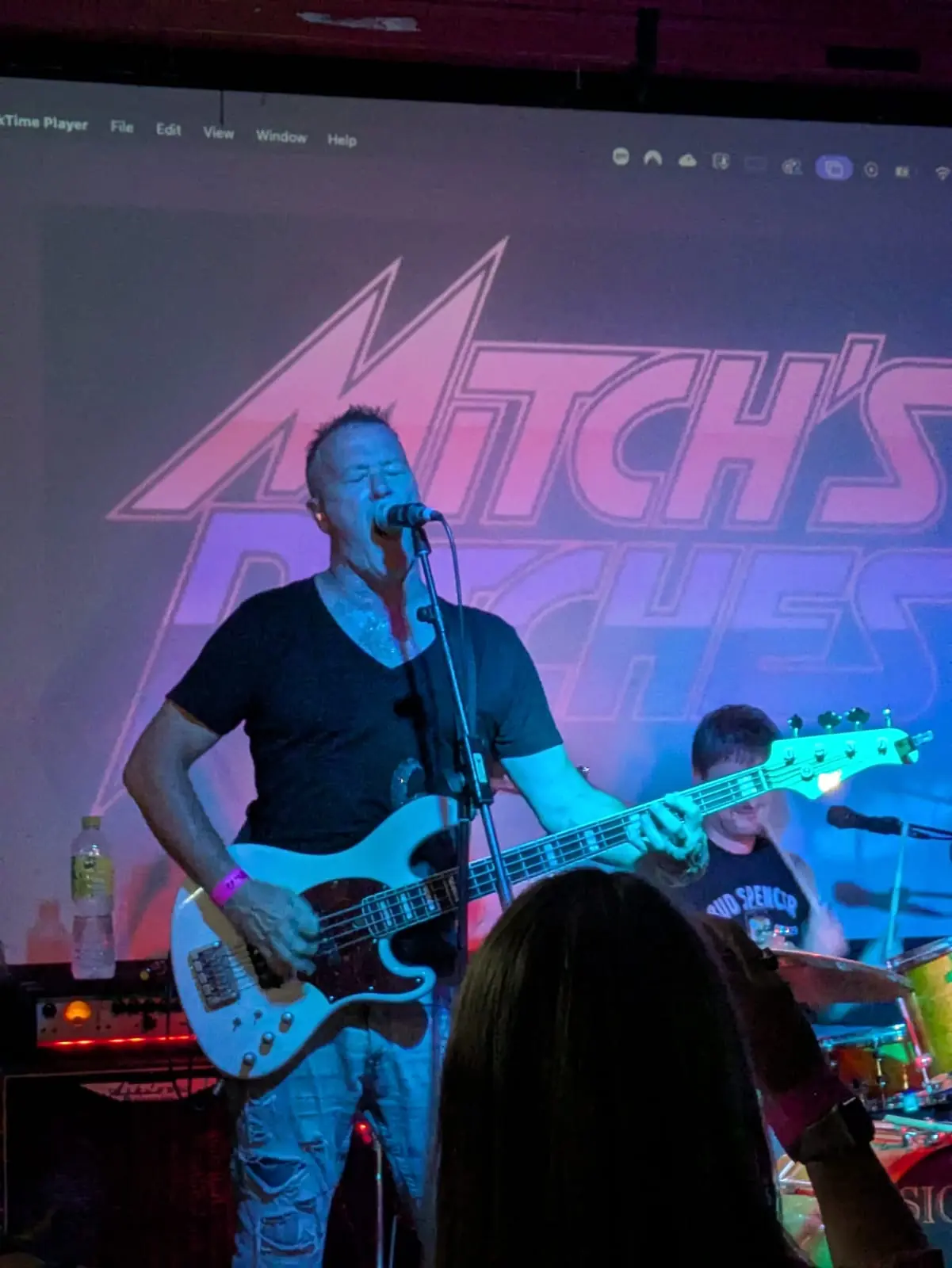 Jez singing while playing bass for Mitch's Bitches